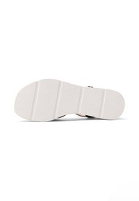 Sole in gomma bianca con superficie texturizzata, dotata di tre scanalature orizzontali. Il design dei colori include accentuazioni più scure nella parte superiore.