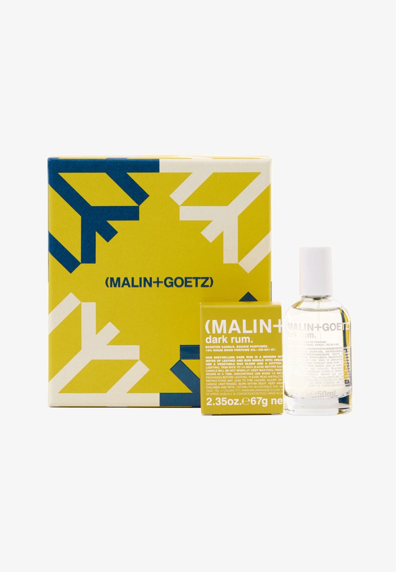 Duftkerze und Duftset in einer gelben Box mit blauen Akzenten. Enthält eine klare Glasflasche mit der Aufschrift „Dark Rum“ und eine passende Box.