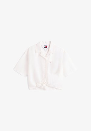 Cămașă albă cu mâneci scurte, nasturi, guler, buzunar la piept, mic logo și nod decorativ în față la tiv.