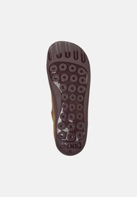 Suela de un zapato marrón con patrones de agarre circulares y ranuras, con el texto "CAMPEAK" y el tamaño "38" visibles.