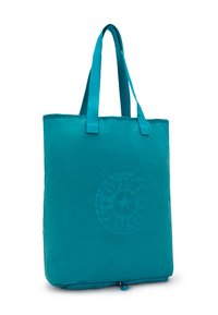 Tealfärgad axelväska gjord av lätt material, med två handtag, en dragkedjeöppning i botten och en cirkulär logotypdesign.