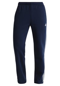 Marineblaue Jogginghosen aus weichem Stoff, mit einer lockeren Passform, elastischem Taillenbund und weißen Seitenstreifen. Mit einem Akzent des Adidas-Logos.