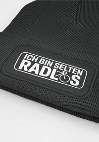 Black knitted beanie featuring a rectangular white patch with the text "ICH BIN SELTEN RADLOS" and a bicycle graphic.