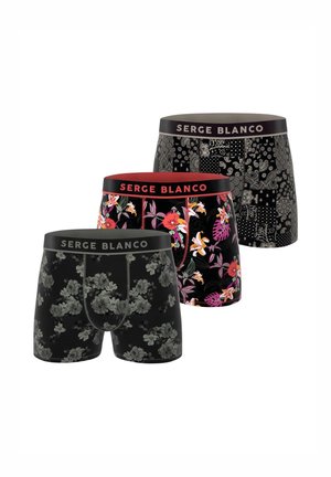 Trois paires de boxers noirs avec différents motifs : floral, abstrait et tropical, tous dotés de ceintures élastiques contrastantes.