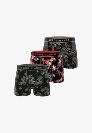Trois paires de boxers noirs avec différents motifs : floral, abstrait et tropical, tous dotés de ceintures élastiques contrastantes.