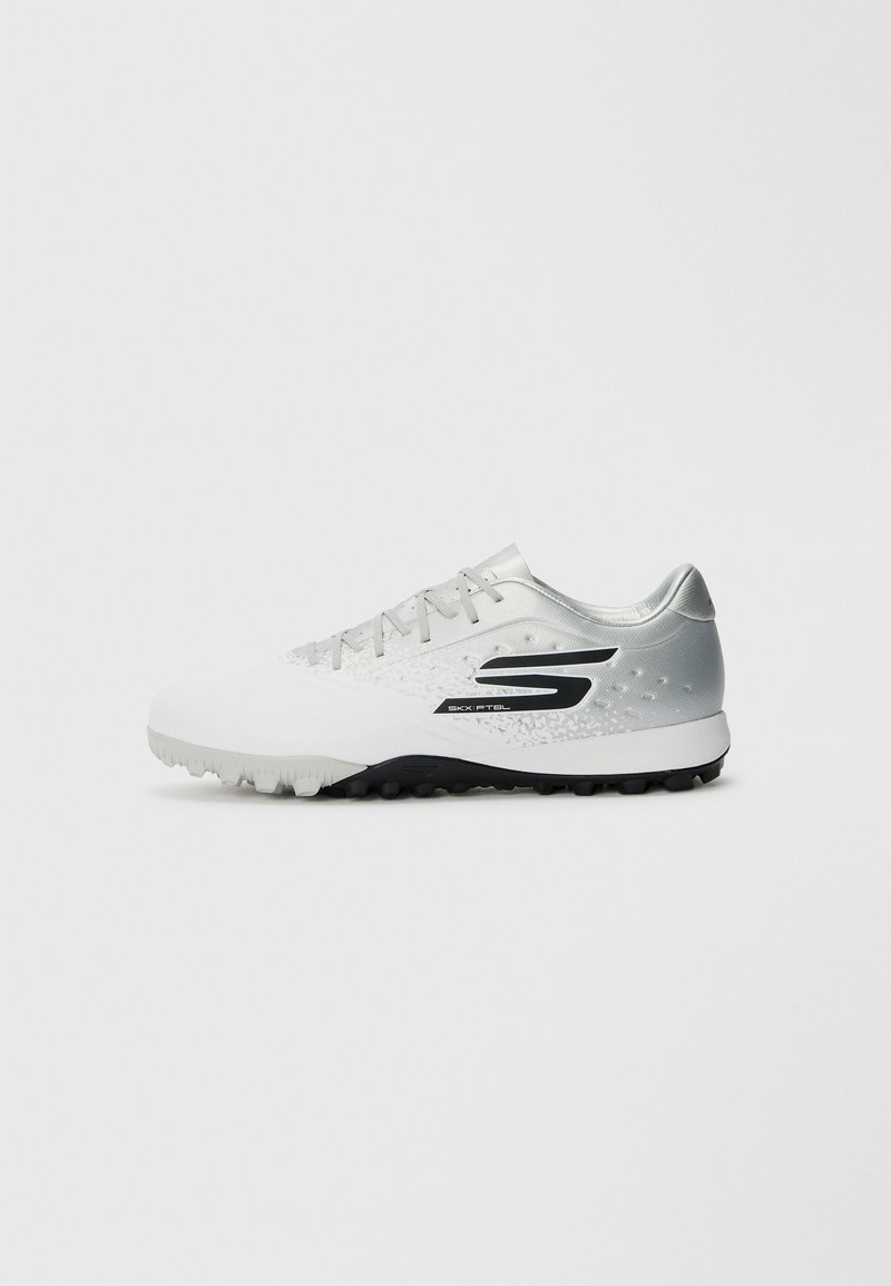 White athletic shoe with a textured silver gradient upper, black accents, and a molded rubber outsole featuring small studs for traction.