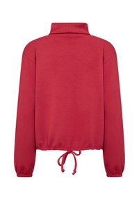 Red, long-sleeve pullover with a high collar and elasticized hem. Features a drawstring at the waist and ribbed cuffs. Soft fabric texture.