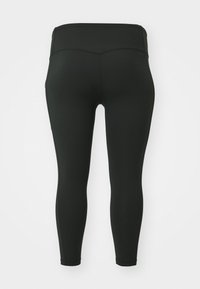 Leggings noirs en tissu extensible, dotés d'une taille haute, d'un ajustement serré et sans motifs ni pièces métalliques visibles. Texture lisse sur toute la surface.