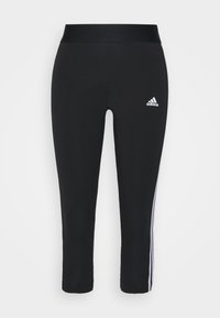 Black Adidas leggings with white side stripes and logo on the left thigh, featuring a high waistband and ankle-length fit.