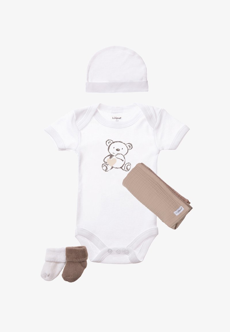 White cotton onesie with a bear illustration, beige muslin cloth, and two pairs of socks (white and brown) laid out together.