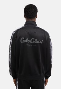 Carlo Colucci - TRACKSUIT JACKET UNISEX - Sportinė striukė - black Miniatiūros vaizdas 1