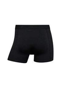 Sorte bomuldsboksershorts med en elastisk talje, der har mærkenavnet prægede. Glat tekstur og en tætsiddende design uden synlige mønstre.