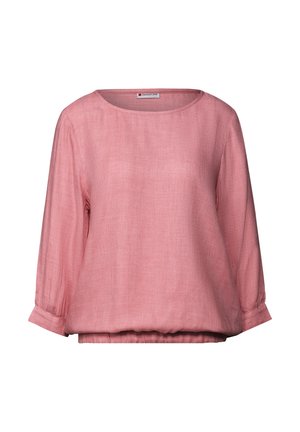 Blusa in lino rosa chiaro con scollatura rotonda, maniche a tre quarti e vita elasticizzata. Presenta un tessuto liscio e strutturato.