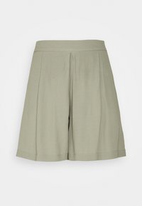 Shorts plissés en tissu doux vert clair avec une texture lisse. Dotés d'une ceinture large et d'une coupe droite et décontractée. Sans poches.