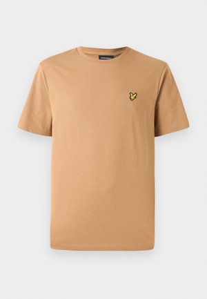 Lyhythihainen pyöreäkauluksinen t-paita vaaleanruskeasta puuvillasta, jossa on pieni keltainen brodeerattu logo vasemmassa rinnassa. Sileä pinta.