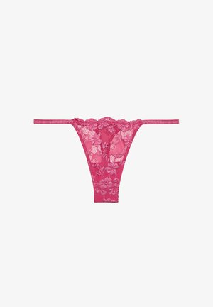 Pink lace thong with floral pattern, thin side straps, and semi-sheer texture, featuring a delicate design and detailed edges.