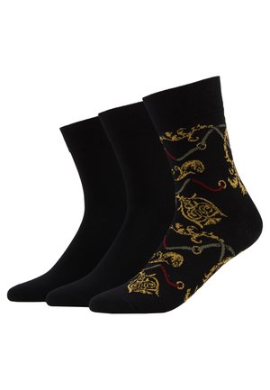 Drei Paar Knöchelsocken. Ein Paar in einfarbigem Schwarz, zwei mit aufwendigen goldenen und roten Blumenmustern auf schwarzem Hintergrund. Material aus Baumwollmischung.