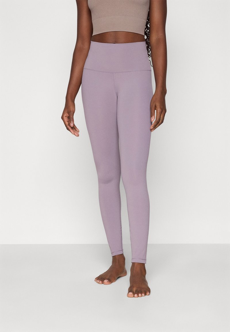 Light purple high-waisted leggings made from stretchy fabric, featuring a smooth texture and seamless design. No visible patterns or logos.