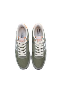 Green mesh sneakers with white laces, orange accents, and gray rubber soles. Features U.S. Polo Assn. branding on the tongue.