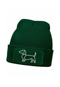Green ribbed beanie hat with a fold-over cuff featuring a white outline of a dachshund on a rectangular patch. Soft knit texture.