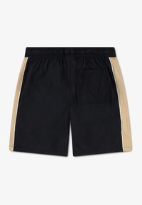 Shorts noirs avec panneaux latéraux beiges, taille élastique et poche arrière. Confectionnés en tissu léger à la texture lisse.