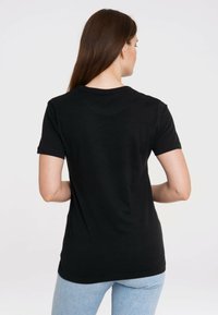 Black cotton t-shirt with short sleeves, crew neck, and a smooth texture, displayed from the back. Fitted design with no visible patterns.