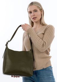 Green leather handbag with a structured design and a wide strap, featuring a smooth texture and gold-tone hardware accents.
