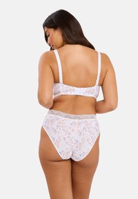 Ensemble soutien-gorge et culotte taille haute en blanc avec un motif floral. Comprend des détails en dentelle, des bretelles ajustables et un tissu doux. Vue arrière affichée.