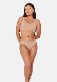 Conjunto de sujetador y bikini en tono nude, de textura suave, con un diseño de escote en forma de V y tirantes suaves, que ofrece un estilo minimalista.