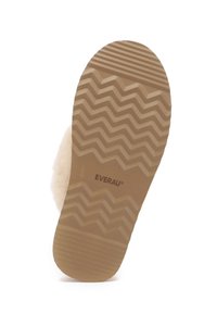 Light tan rubber outsole with zigzag pattern; soft, cream-colored upper material; brand name "EVERAU" printed near the heel.