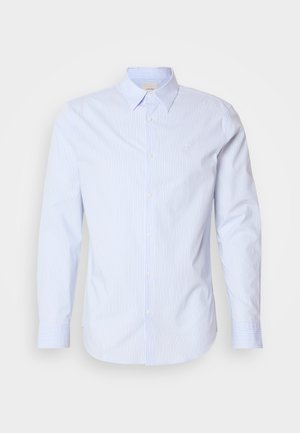 Light blue button-down shirt with thin vertical stripes, long sleeves, and a classic collar. Features a small logo on the chest.