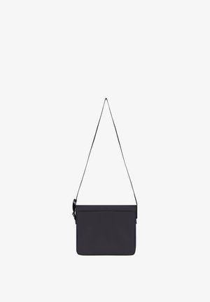 Black rectangular crossbody bag with a thin adjustable strap, front flap closure, and minimalistic design.
