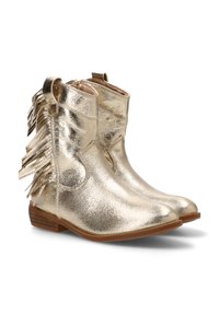 Botines metálicos dorados con detalles de flecos en los laterales, suela plana marrón y textura de cuero suave. Diseño de punta redonda.