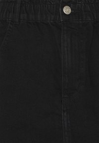 Pantalon en coton noir avec une taille élastique. Doté d'un bouton argenté, d'une poche latérale et d'un tissu texturé. Design simple, sans motifs.