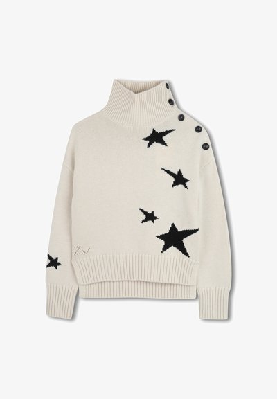 Cream-colored knitted sweater with a high collar, featuring black star patterns and button accents along the shoulder. Ribbed hem and cuffs.