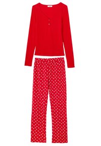 Czerwony prążkowany top z długim rękawem z trzema guzikami oraz pasujące czerwone spodnie piżamowe z białym kwiatowym wzorem. Miękki, wygodny materiał.