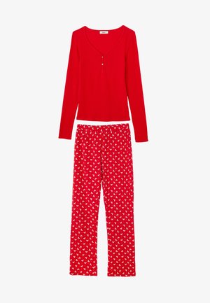 Haut rouge à manches longues côtelé avec trois boutons et pantalon de pyjama assorti rouge à motif floral blanc. Matière douce et confortable.