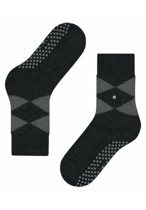 Szare skarpetki w wzór argyle w ciemniejszych i jaśniejszych odcieniach. Teksturalne wypustki na podeszwie. Żebrowany mankiet u góry.