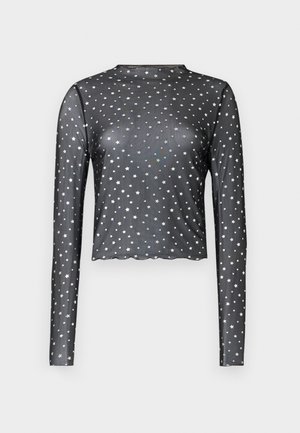 Black long-sleeve top made from sheer fabric, featuring a scalloped hem and silver star print throughout. Form-fitting design.