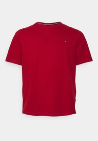 Red T-shirt made of cotton, featuring a crew neckline and short sleeves. Includes a small logo accent on the left chest area.