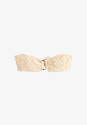 Beige bandeau-bikinitop med tekstur, centralt knude og lille detaljeret skildpaddeskalsring, vist på en hvid baggrund.