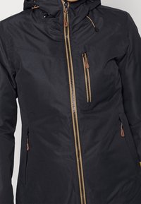 Schwarze, wetterfeste Jacke mit durchgehendem Reißverschluss, braunen Reißverschlussakzenten, Kapuze mit Kordelzügen und seitlichen Reißverschlusstaschen.