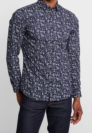 Marineblauw overhemd met knopen, voorzien van een wit bloemen-paisleypatroon, lange mouwen en een klassieke kraag. Gemaakt van een zachte, gestructureerde stof.
