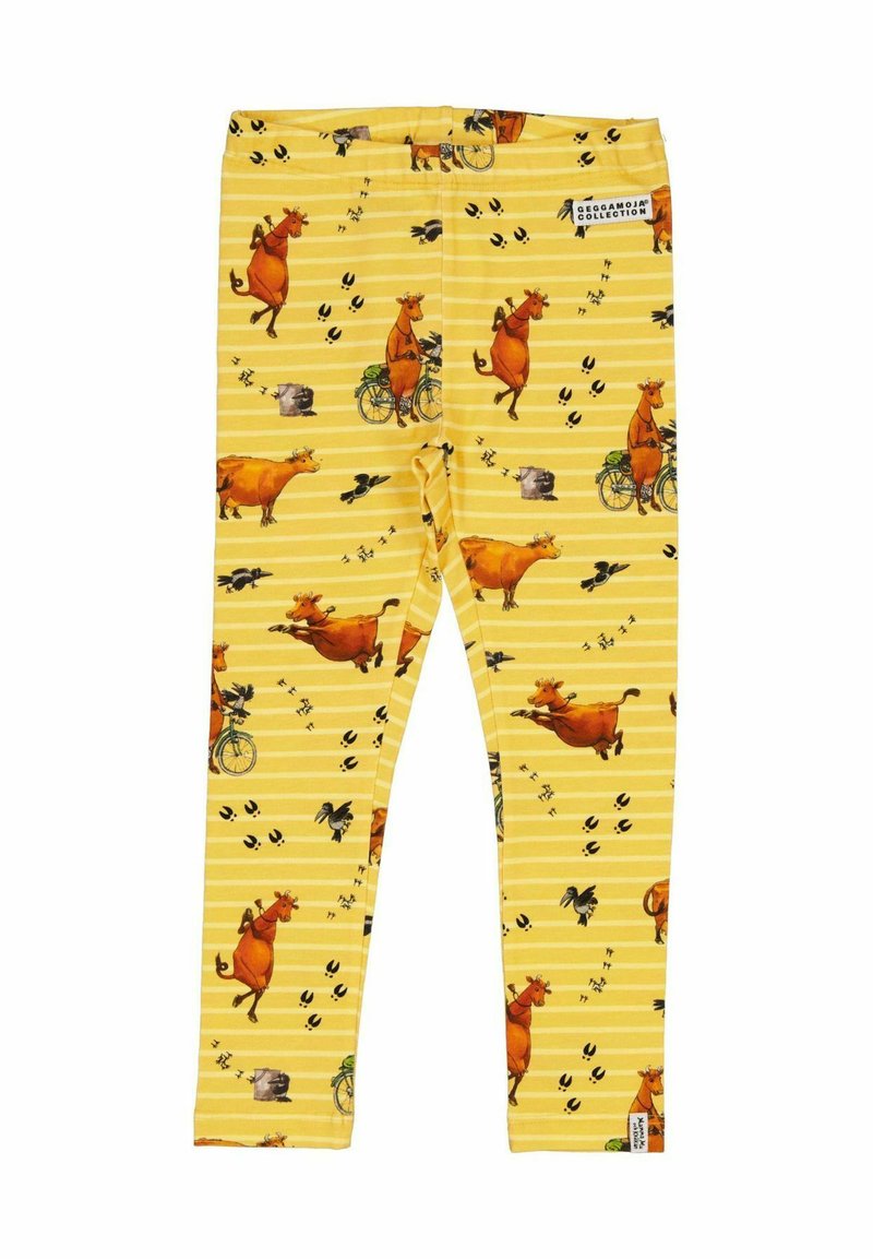 Keltaiset leggingit, joissa on leikkisä lehmäkuvio, jossa lehmiä pyöräilemässä, mustia jalanjälkiä ja raidoitettu tausta.