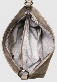 Sac à main beige avec fermeture éclair ouverte montrant l'intérieur en tissu gris clair, plusieurs compartiments et une doublure imprimée de texte.