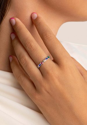 Anello d'argento con diverse gemme in rosso, blu, verde e giallo, impreziosito da un design geometrico su una sottile fascia.