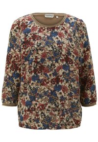 Blommönstrad långärmad topp med en beige bakgrund och röda, blå och svarta blommor. Rund halsringning med en kontrasterande kant.