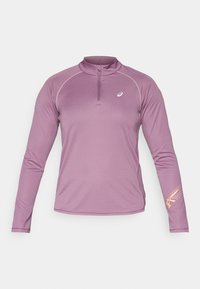 Laventelinvärinen långärmad träningströja med kvartslång dragkedja, vit pipingdetalj och små vita och orange logotyper på bröstet och ärmen.