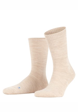 Beige Sneakersocken mit einer gerippten Textur. Weicher Stoff, verstärkte Spitze und Ferse; mit kleinem blauem Logo an der Seite.