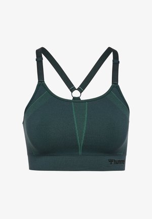 Sportbeha in donker groen, gemaakt van gestructureerde stof. Voorzien van verstelbare crisscross-schouderbanden en een cirkelvormige hardwareaccent. Logo op de band.